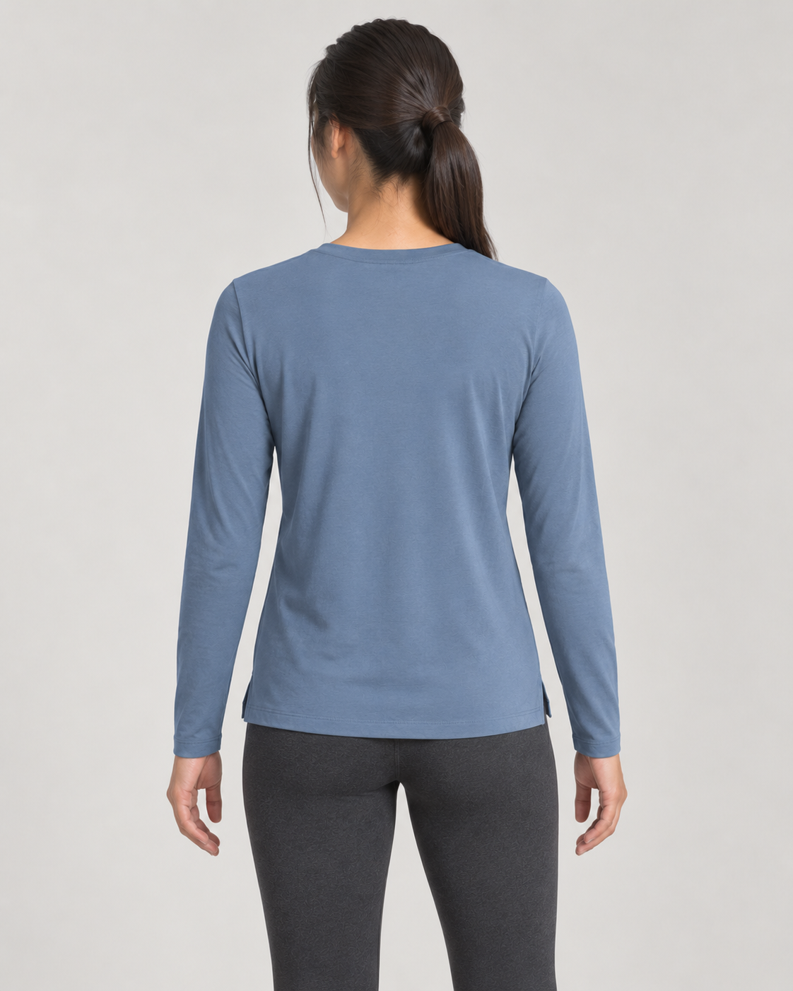 Concept mockup: Akumi Reset Long Sleeve Crew in Slate Blue, back view on an adult woman.