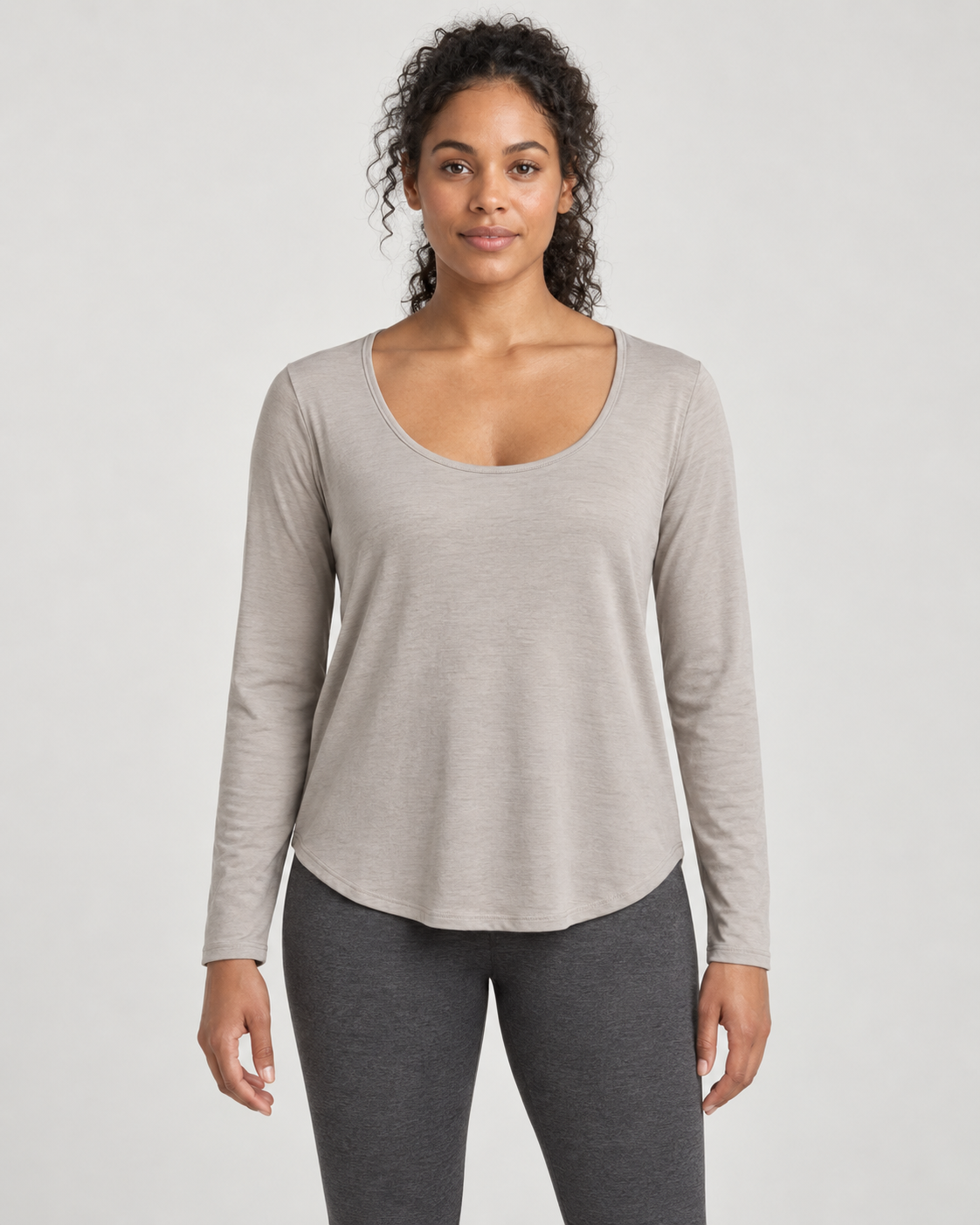 Concept mockup: Akumi Drift Scoop Long Sleeve in Stone, front view on an adult woman.