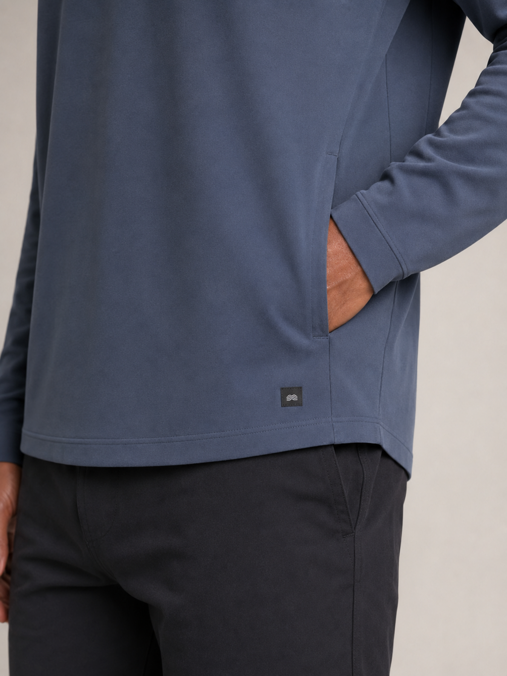 Pocket, technical fabric and woven patch detail of Akumi AeroLayer Travel Hoodie