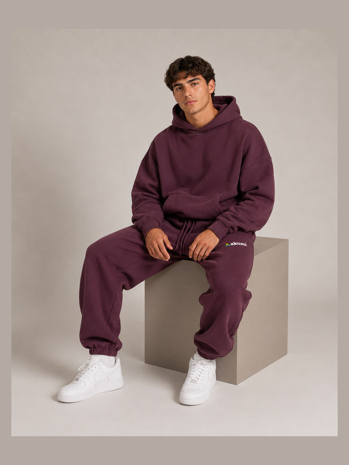 Akumi After Class Sweatpant in Mulberry, male model seated view