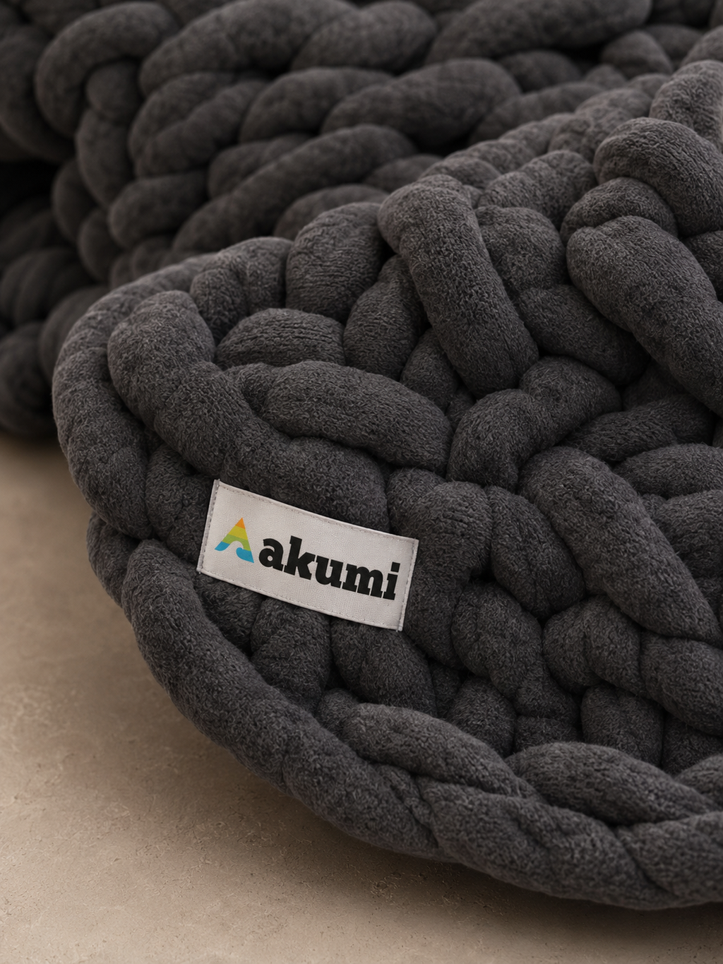 Close detail of Akumi Anchor Blanket weighted loop texture and woven label