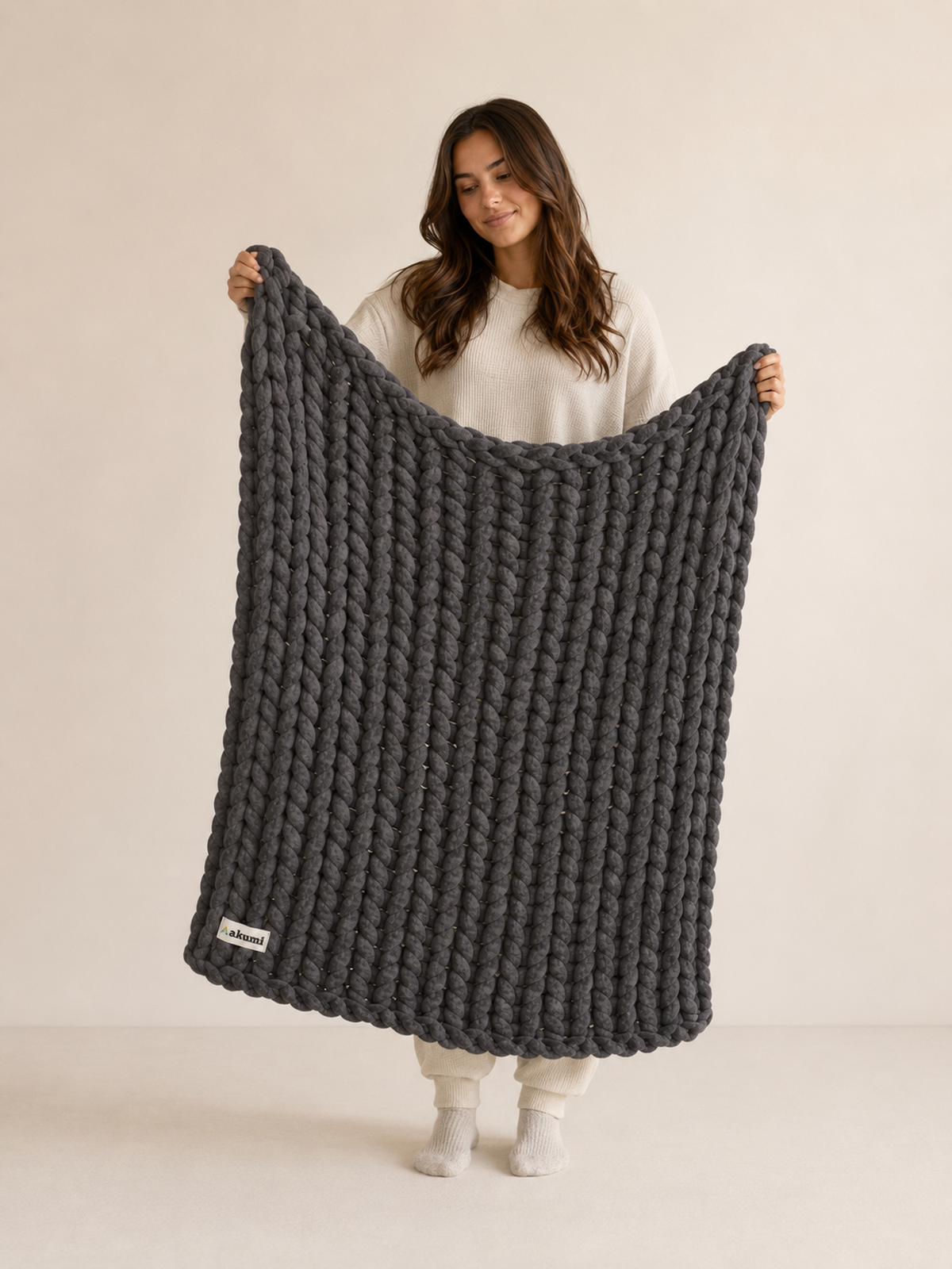 Model holding Akumi Anchor Blanket to show 48 by 72 inch scale