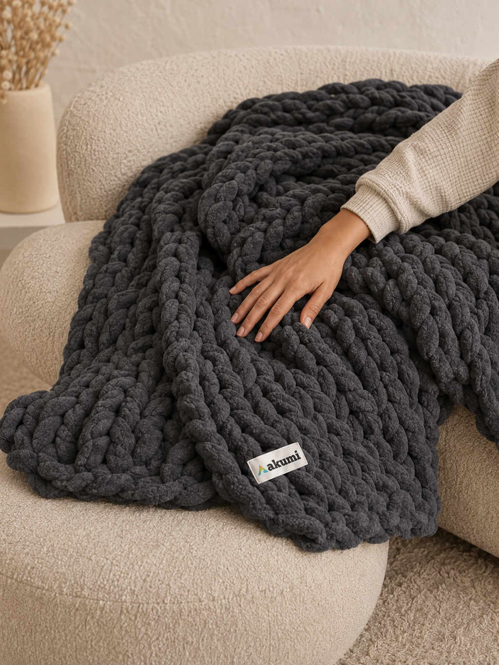 Hand pressing into Akumi Anchor Blanket showing soft weighted loop construction