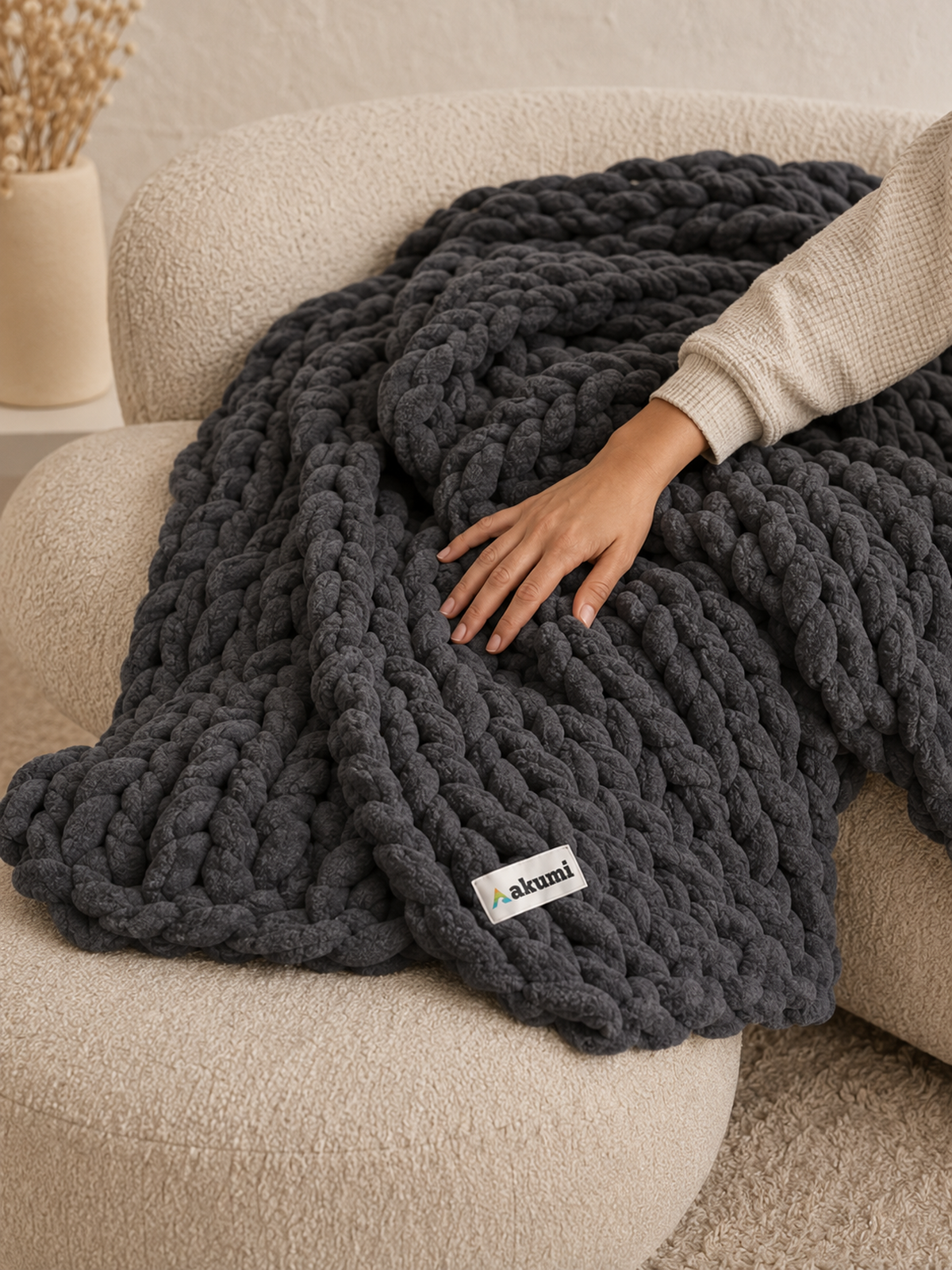 Hand pressing into Akumi Anchor Blanket showing soft weighted loop construction