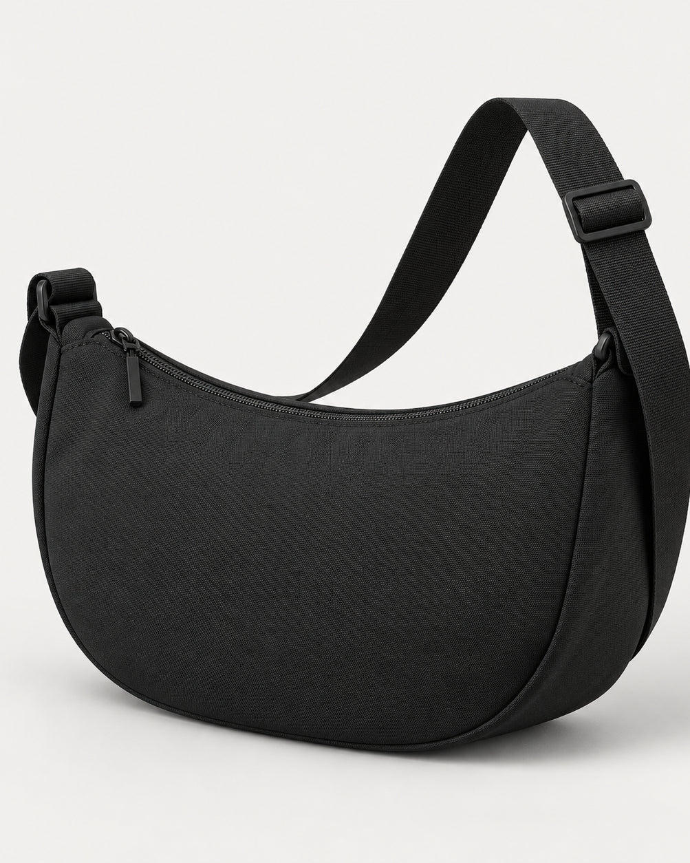Akumi Arc Crossbody in Black, front three-quarter studio concept visualization.