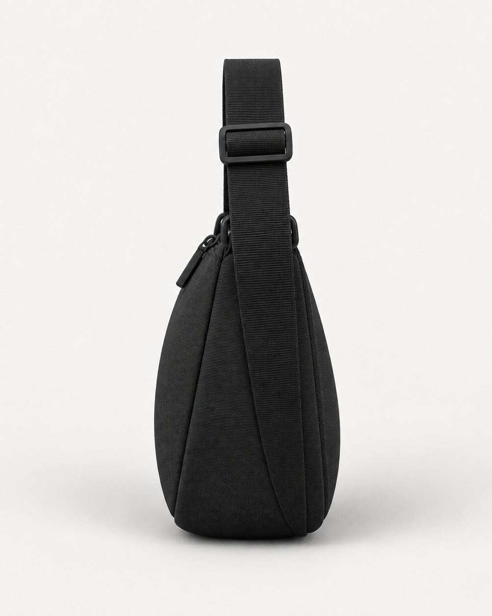 Akumi Arc Crossbody in Black, right-side profile studio concept visualization; proposed design pending sample confirmation.