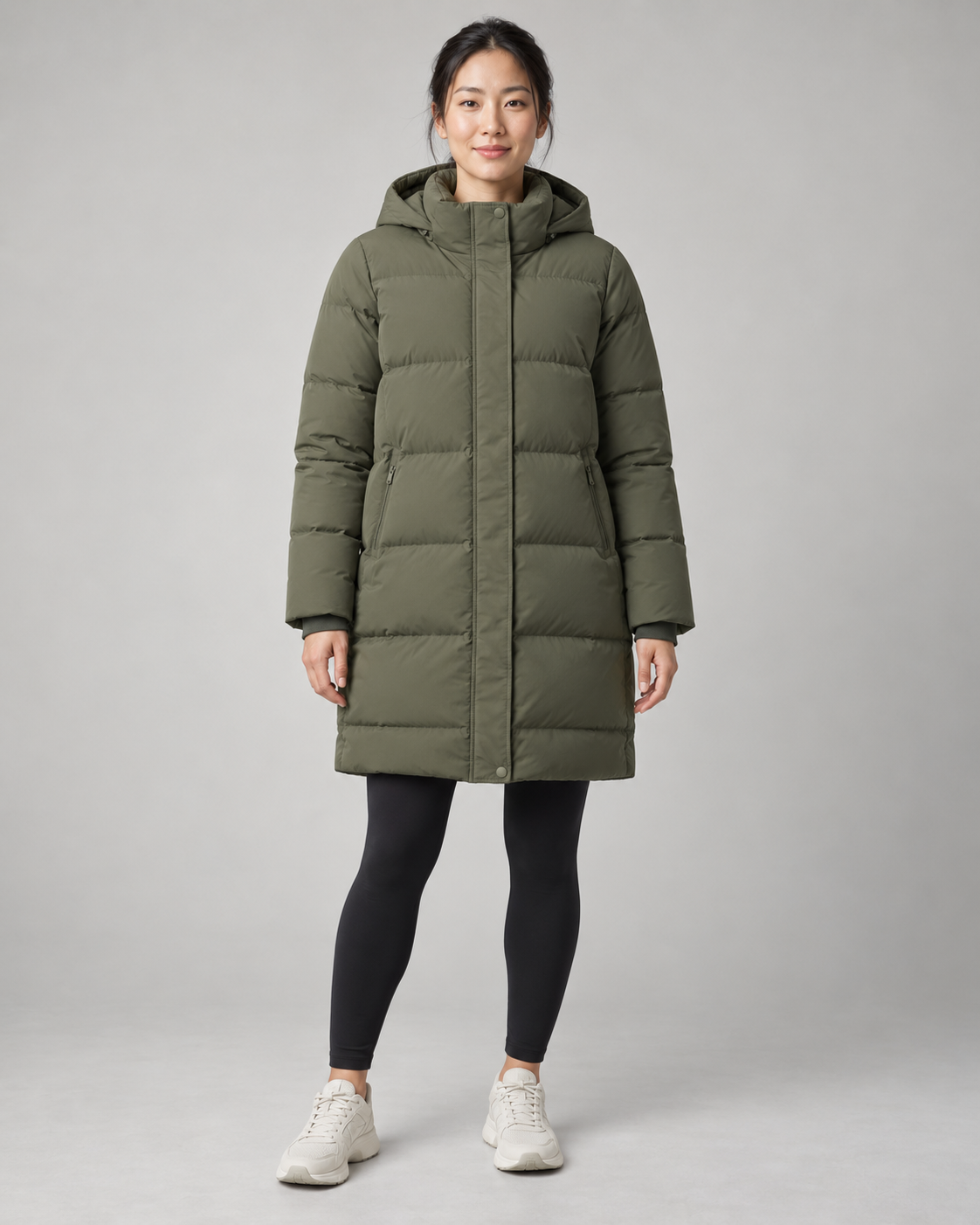 AI-generated design concept: Akumi Arc Longline Puffer in Moss, front view on an adult woman.