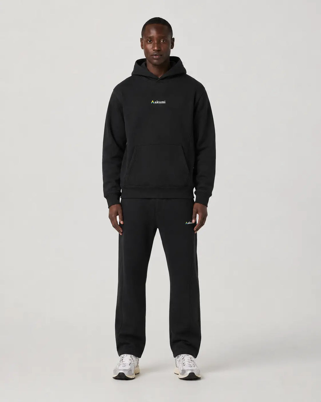 Model wearing the Black Akumi Axis Hoodie and Sweatpant Set, front view