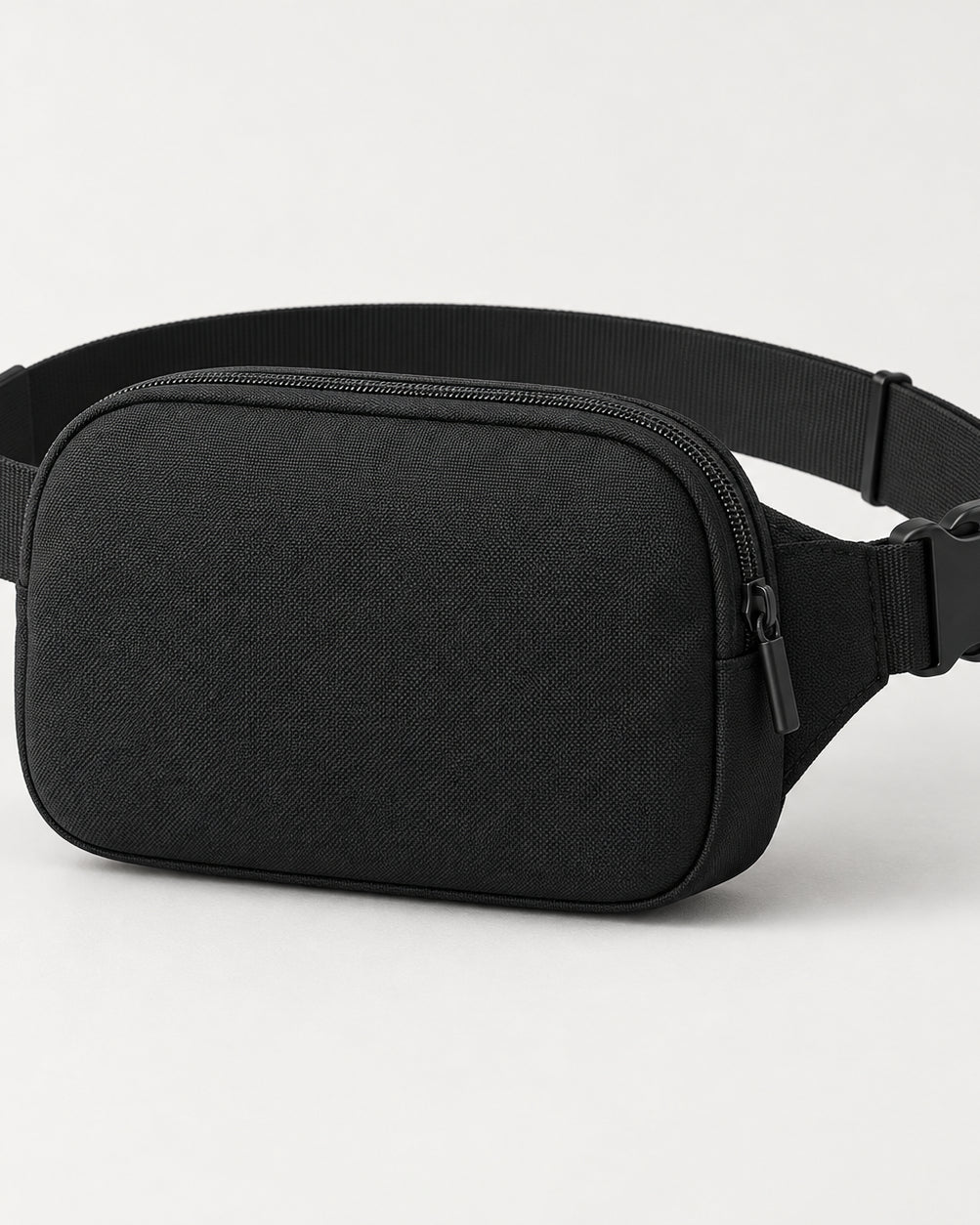 Akumi Close Belt Bag in Black, front three-quarter studio concept visualization.