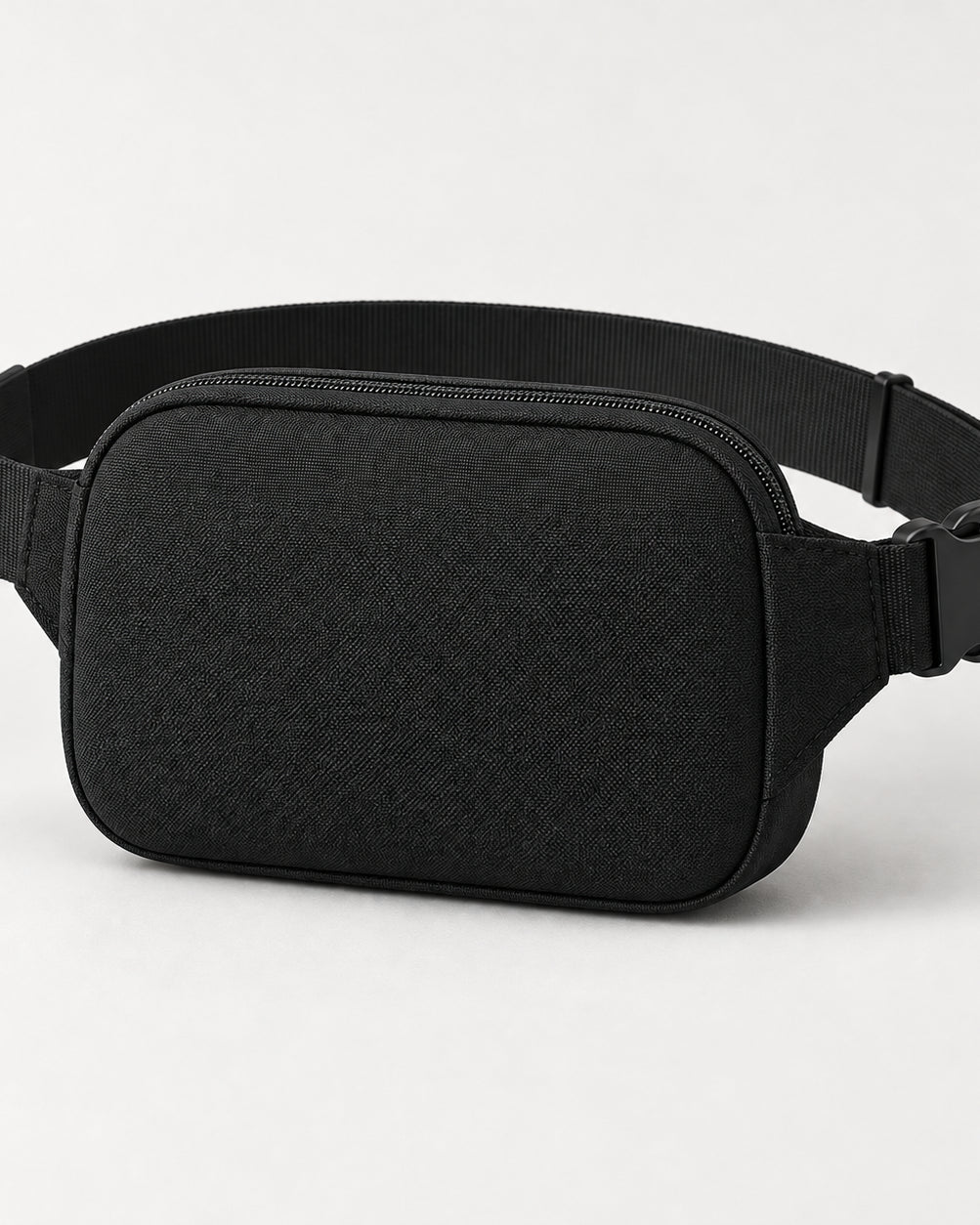 Akumi Close Belt Bag in Black, rear studio concept visualization; proposed design pending sample confirmation.