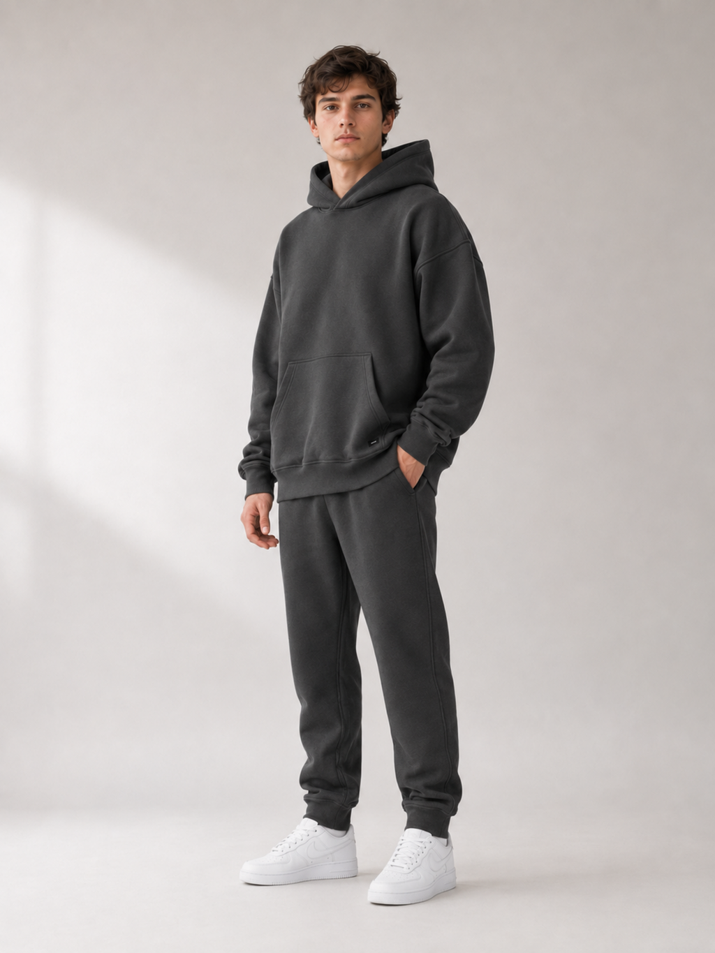 45-degree view of Akumi Collegiate Motion Hoodie in charcoal