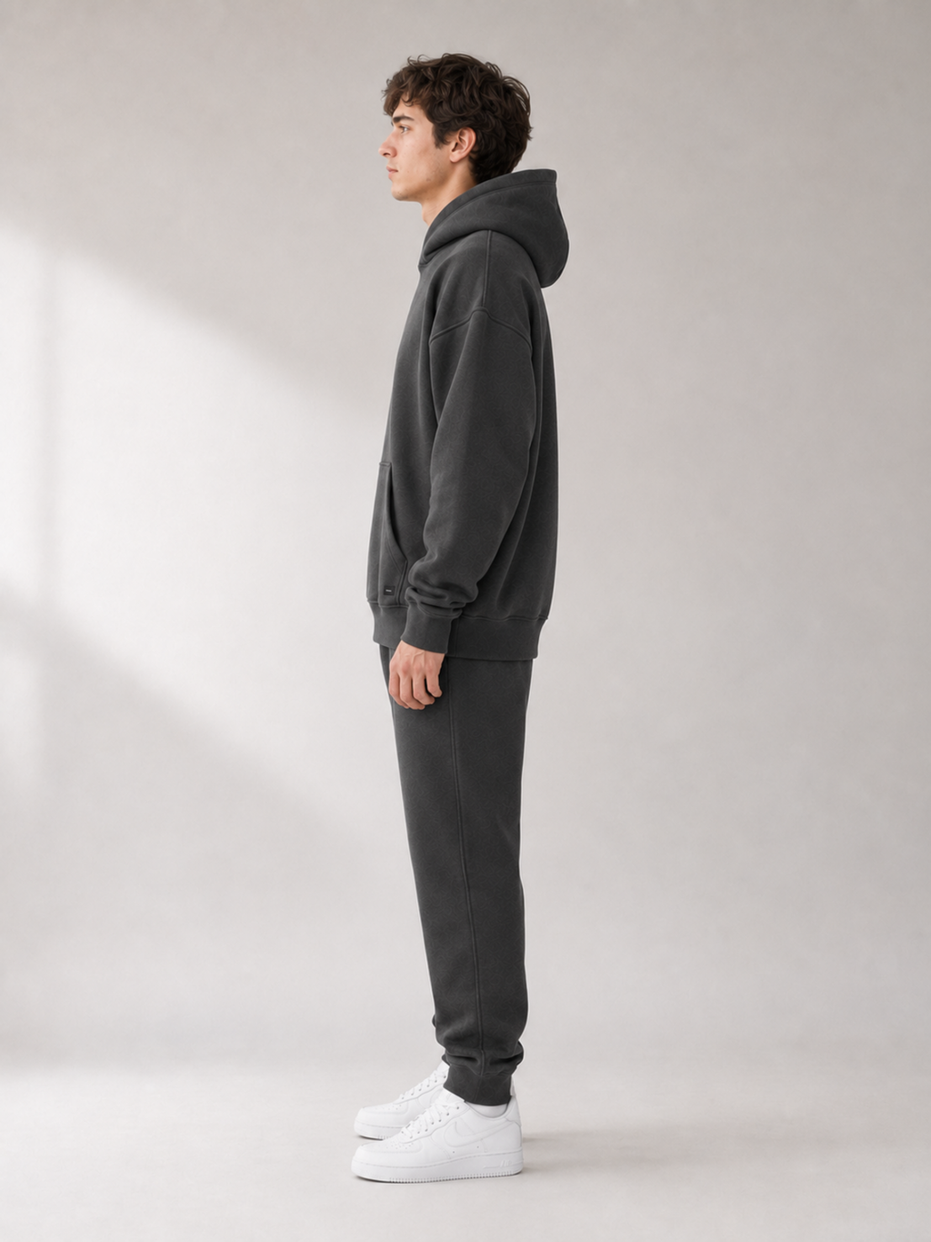 Side view of Akumi Collegiate Motion Hoodie in charcoal