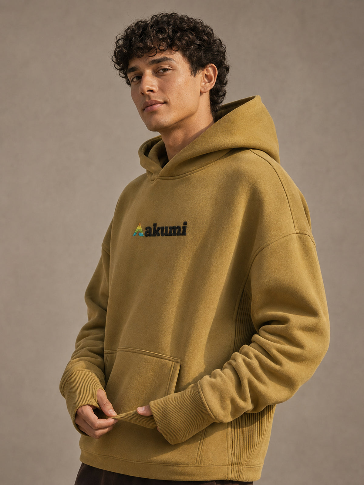 Akumi Crestline Hoodie in Golden Moss — logo and cuff detail