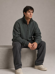 Akumi Crestline Quarter Zip in Slate Pine seated studio styling