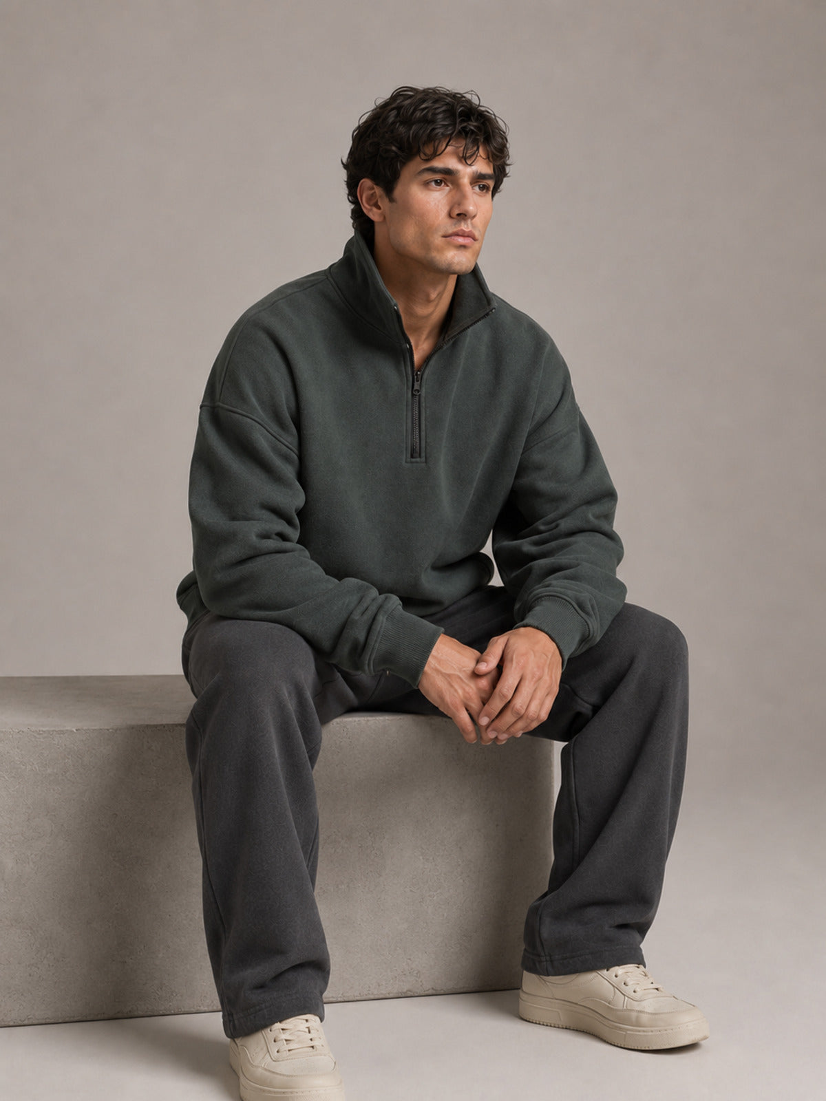 Akumi Crestline Quarter Zip in Slate Pine seated studio styling