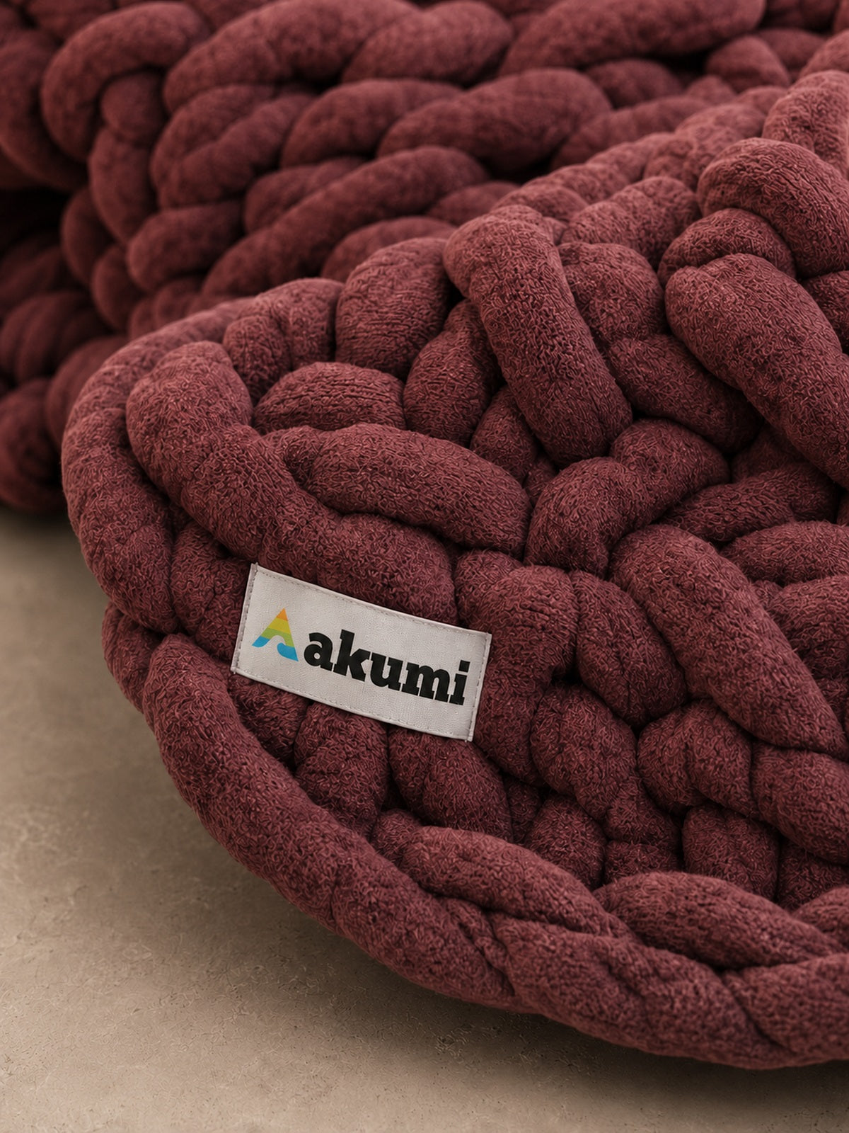 Akumi Emberloop Weighted Blanket Mulberry Clay close-up woven hem label detail