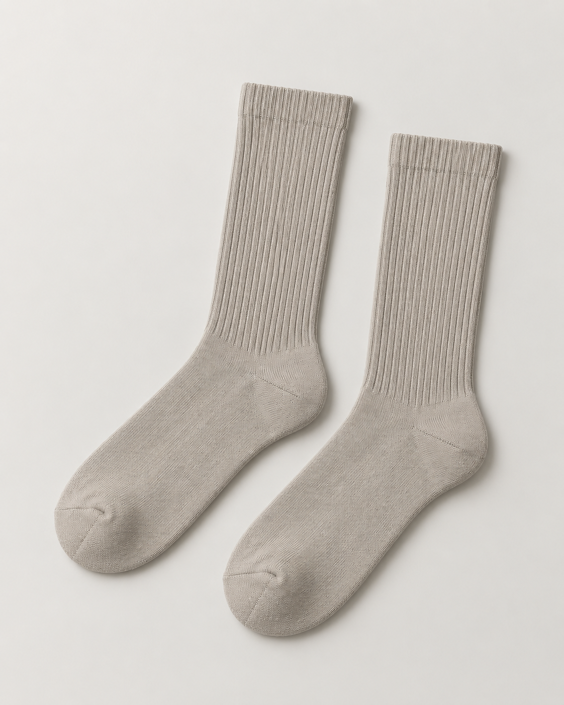 Concept mockup of a pair of stone Akumi Essential Crew Socks with long ribbed shafts.