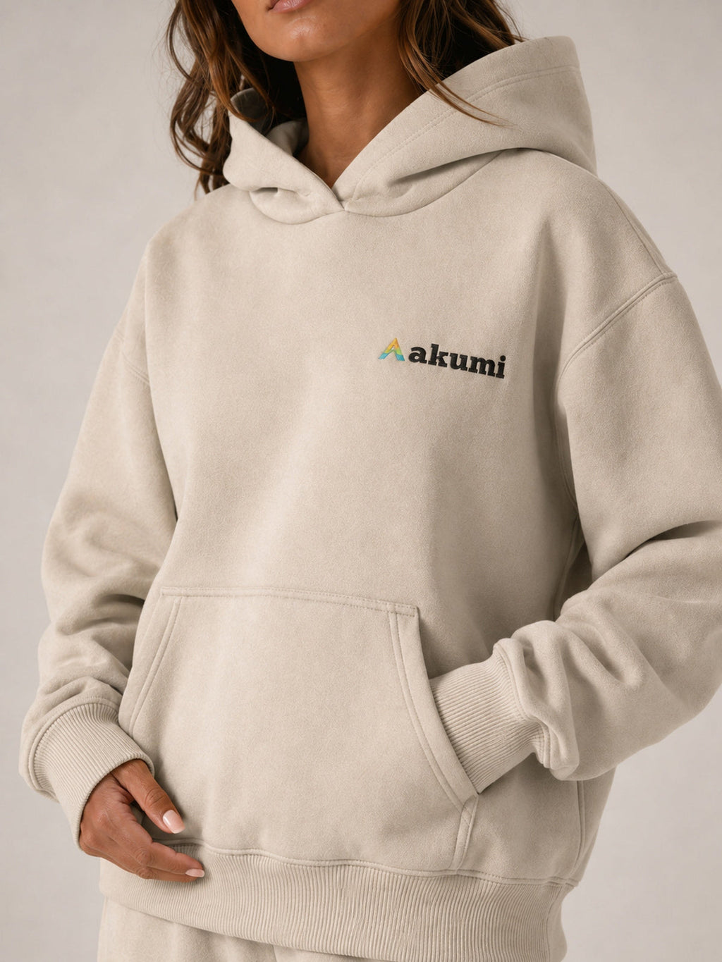 Akumi Essential Hoodie in Stone, embroidered Akumi logo and kangaroo pocket detail