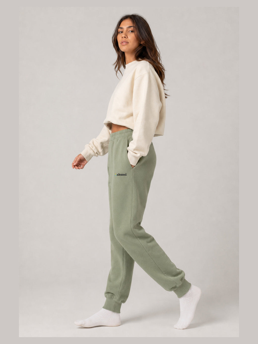Akumi Groundform Sweatpant in Washed Sage, side walking studio view