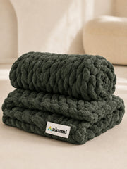 Akumi Grovehold Weighted Blanket Evergreen Ash folded view with sewn woven hem label