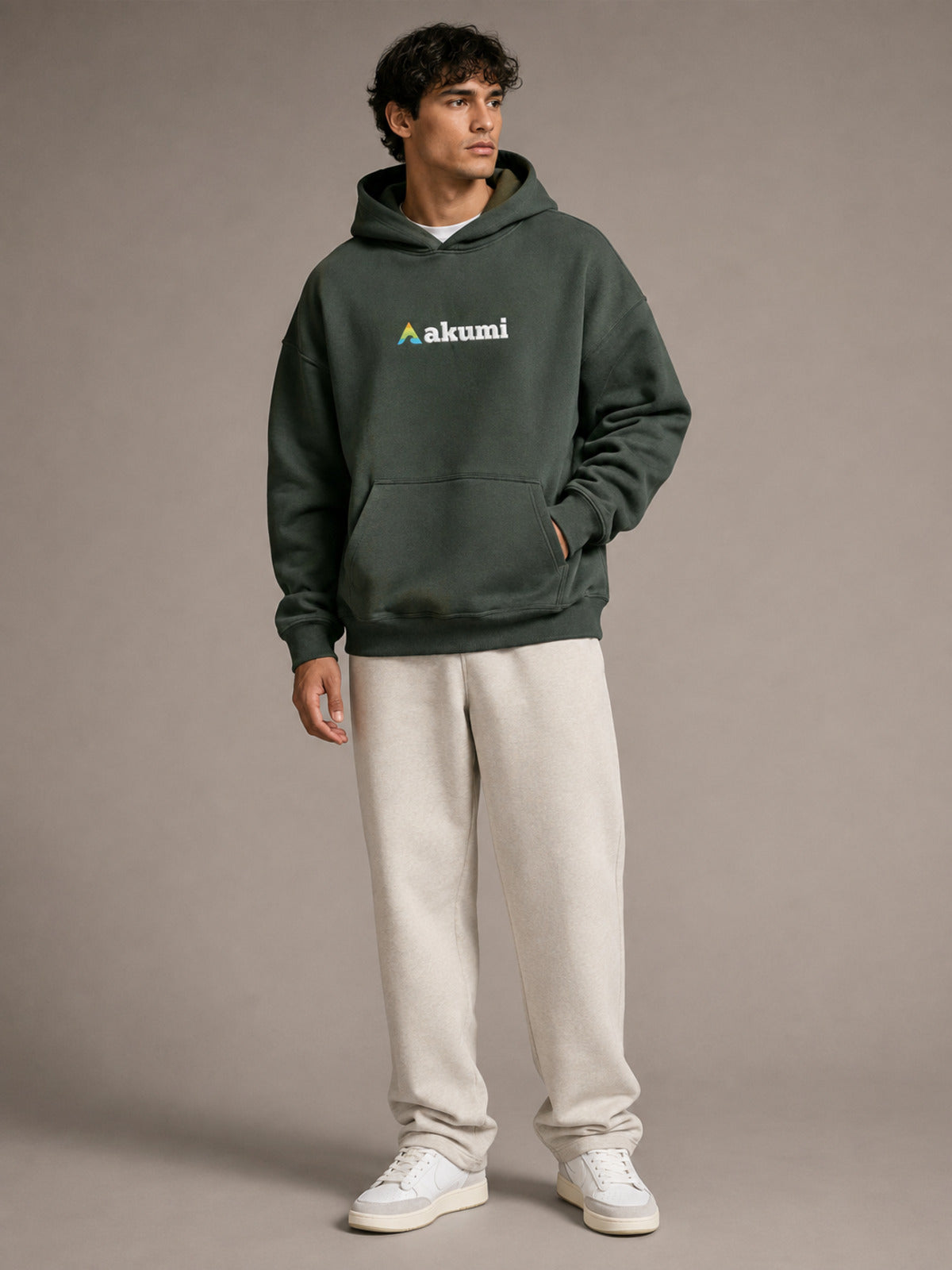Akumi Hushweight Hoodie in Ash Pine male full-body front three-quarter studio view