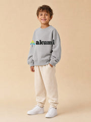 Akumi Little Varsitymark Crew Campus Grey three-quarter view with realistic embroidered Akumi logo