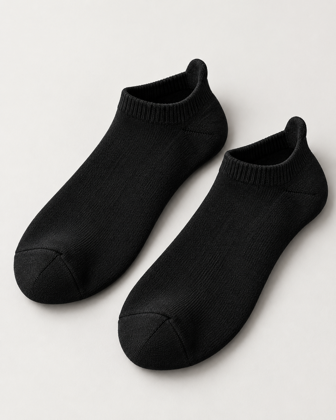 Concept mockup of a pair of black Akumi Motion Tab Socks with raised heel tabs.