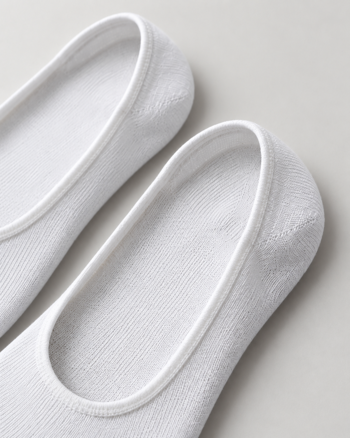 Akumi Everyday No-Show Sock in White, heel opening detail; generated design concept, not a physical-product photograph.