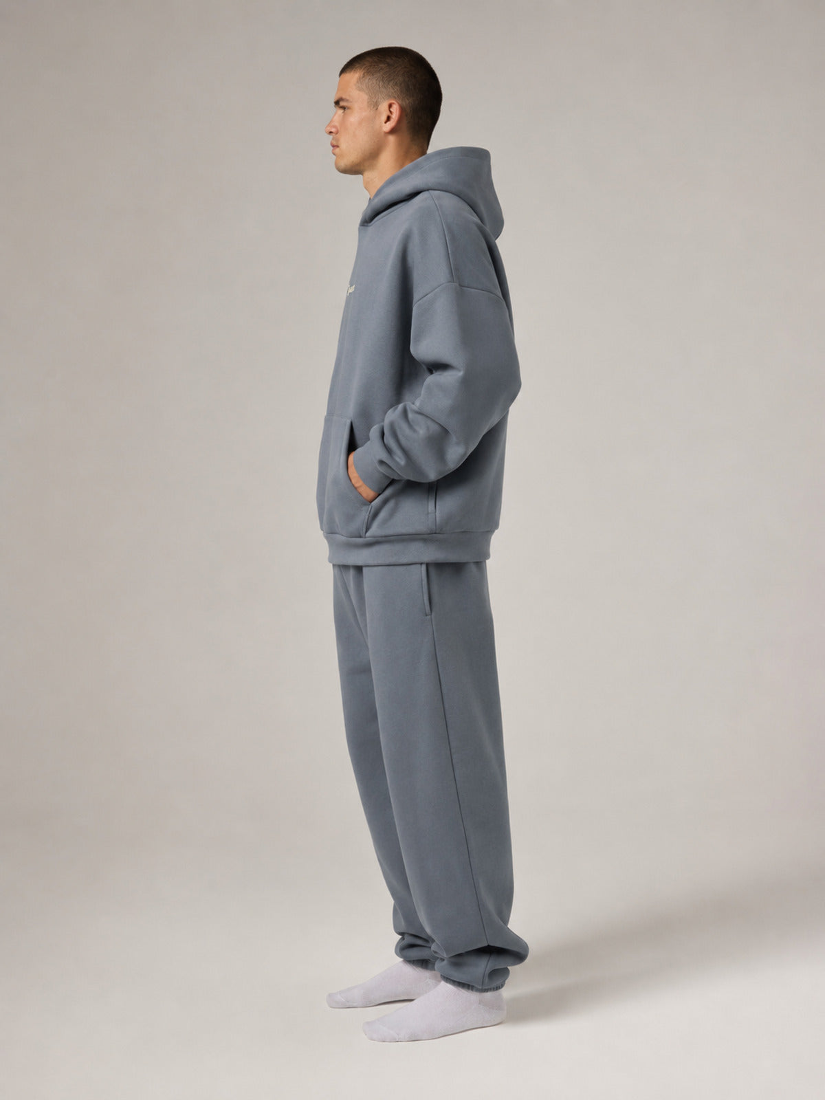 Akumi Reserve Pocket Hoodie in Harbor Ash male full-body side studio view