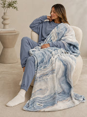 Akumi Shoreline Blanket in Mineral Tide styled on seated model