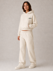 Akumi Softbreak Crop Hoodie in Salt Cream, three-quarter view with consistent left-chest embroidery