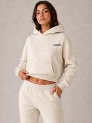 Akumi Softbreak Crop Hoodie in Salt Cream, fit detail with consistent left-chest embroidery
