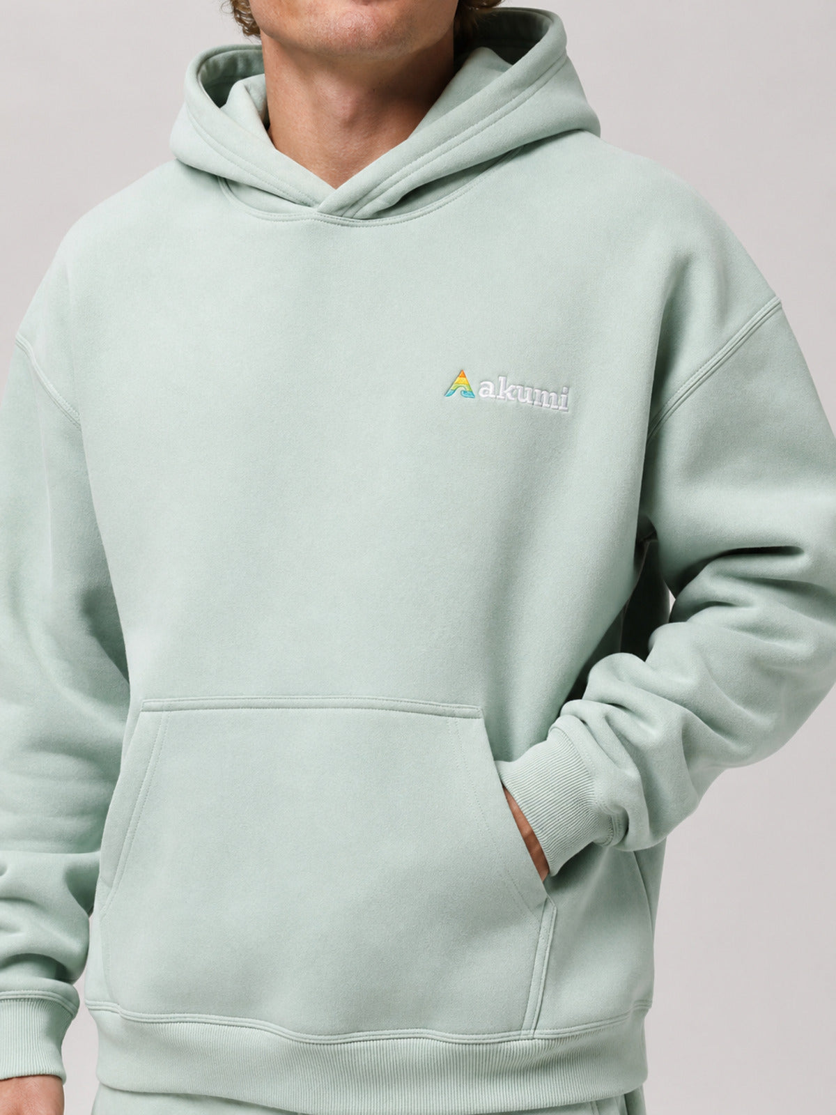 Akumi Softglow Hoodie in Glacier Mint embroidery and pocket detail