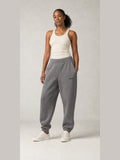Akumi Stillform Sweatpant in Mineral Grey with full Akumi logo, front three-quarter view