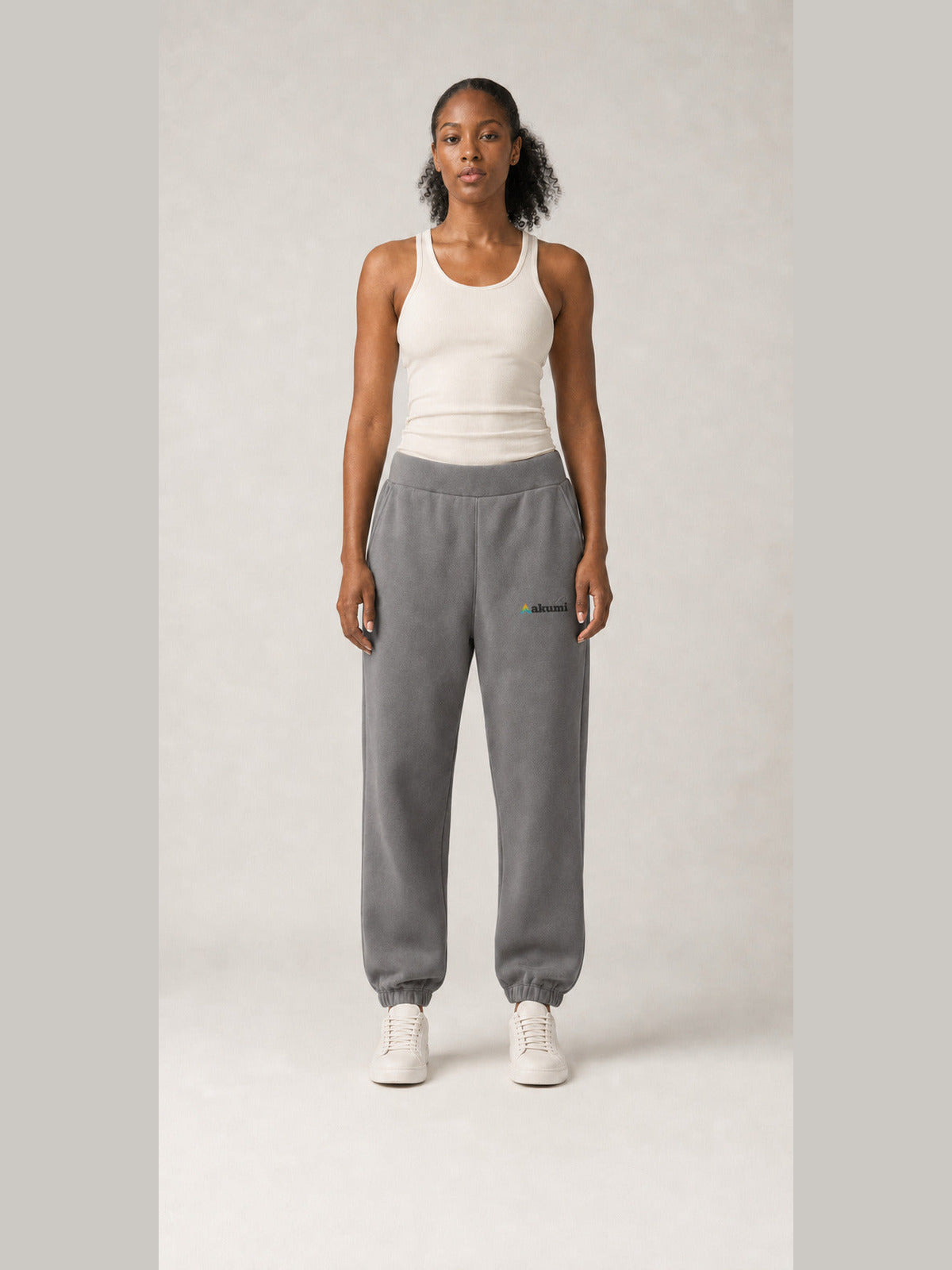 Akumi Stillform Sweatpant in Mineral Grey with full Akumi logo, straight front view