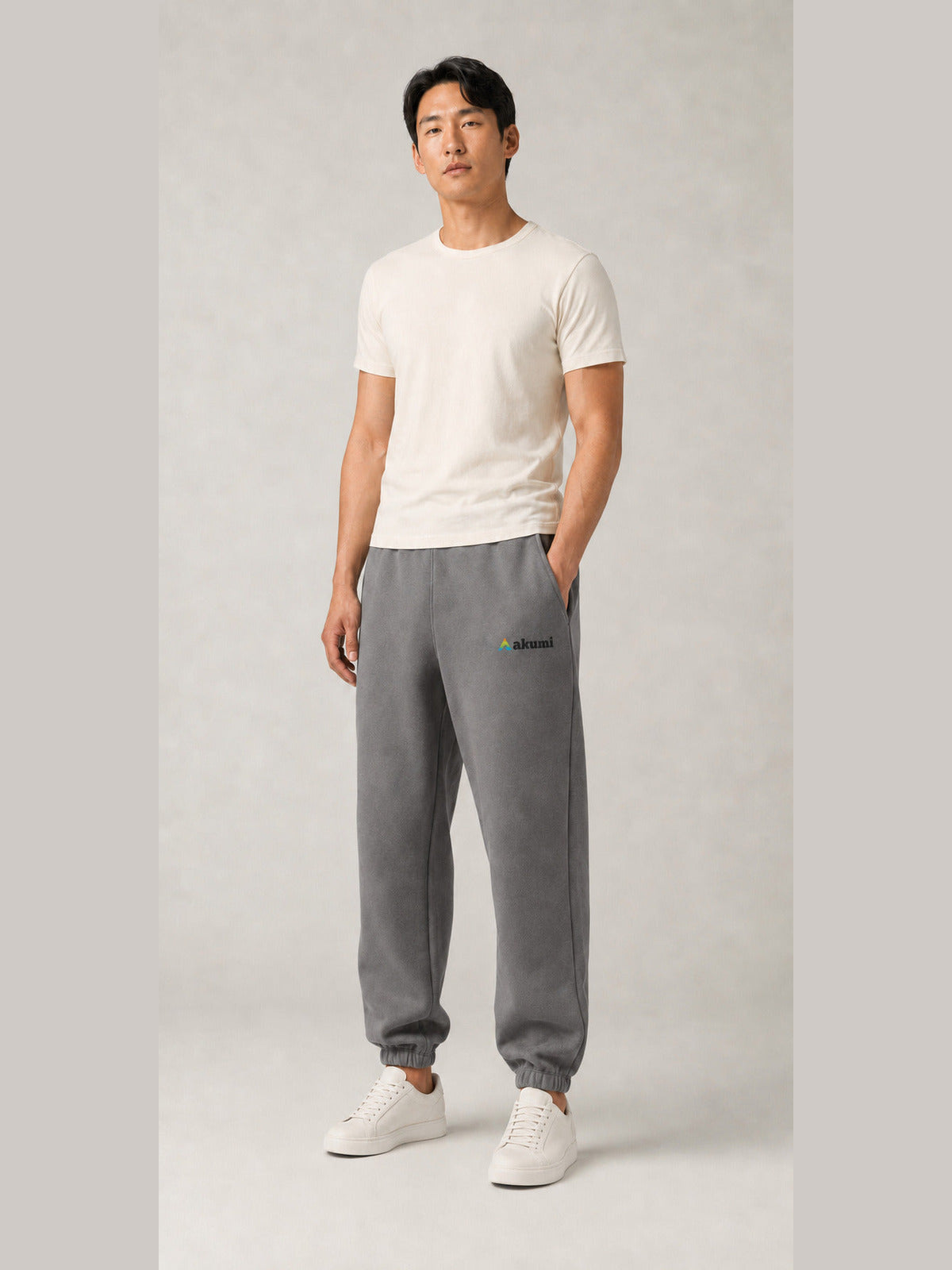 Akumi Stillform Sweatpant in Mineral Grey with full Akumi logo, men's front view