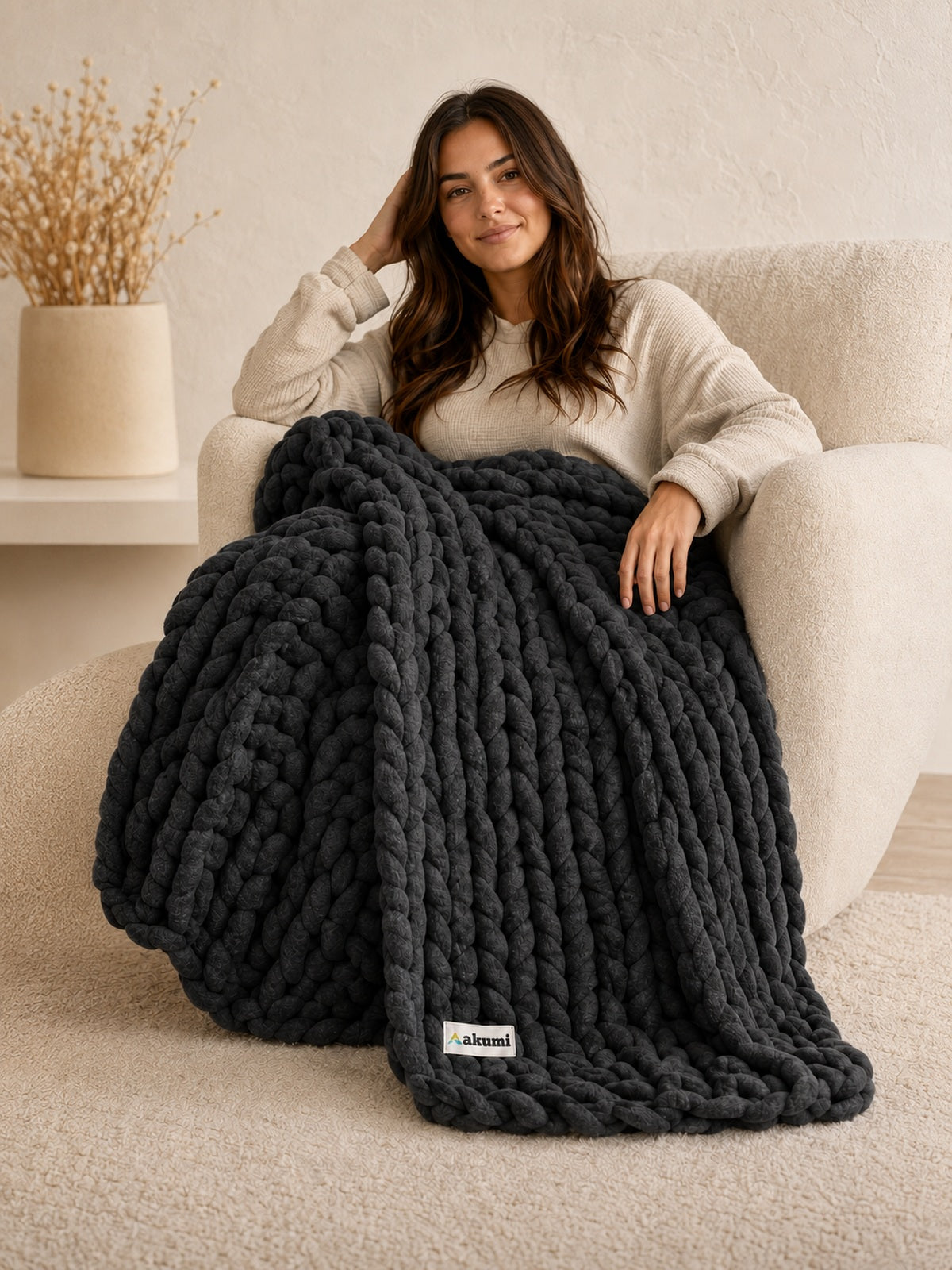 Akumi Stonehold Weighted Blanket Carbon Slate hero view with sewn woven hem label