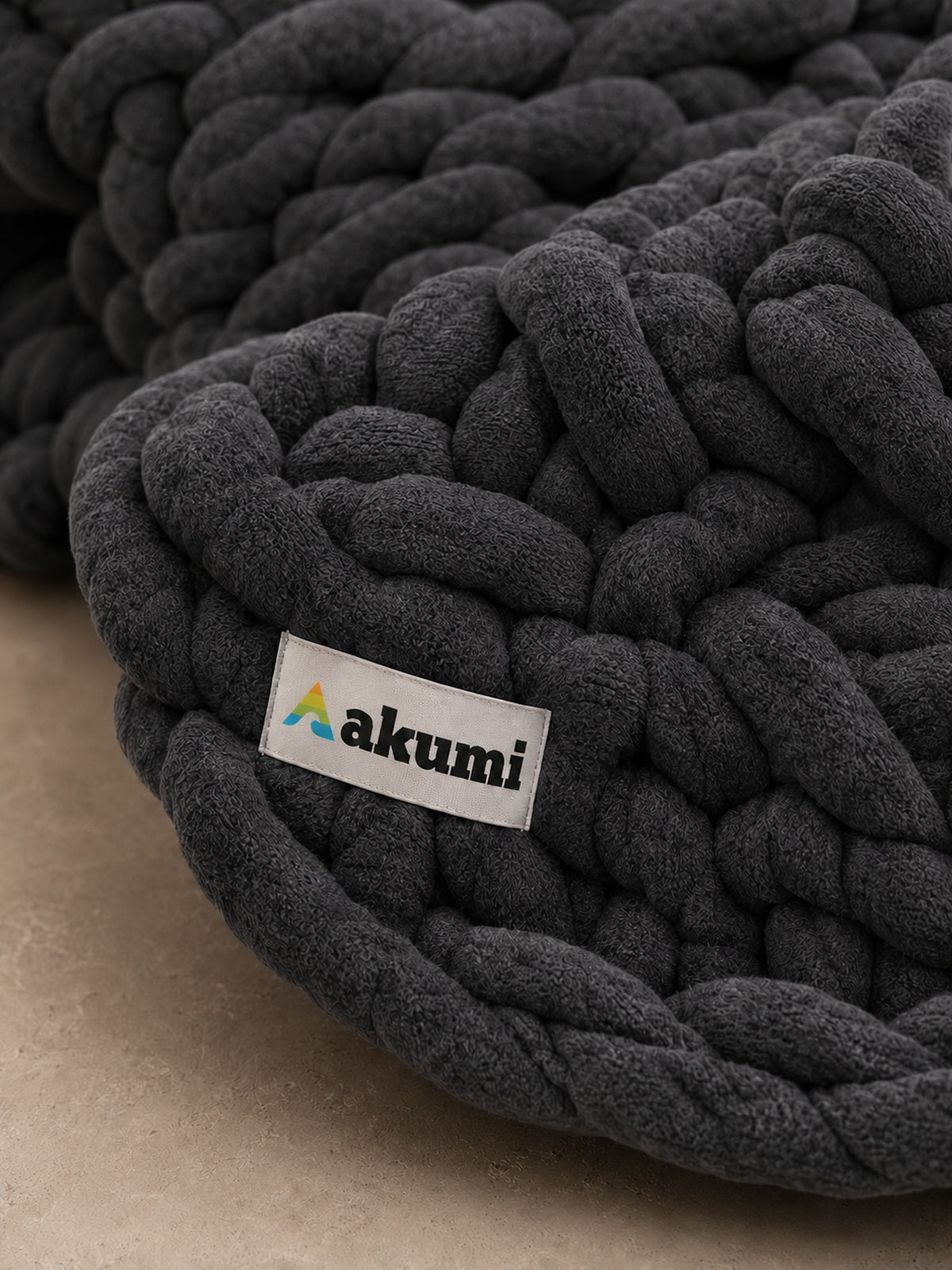 Akumi Stonehold Weighted Blanket Carbon Slate close-up woven hem label detail