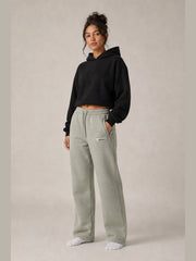 Akumi Transitline Straight-Leg Travel Sweatpant in Sage Fog, cleaned Akumi logo, female model three-quarter front view