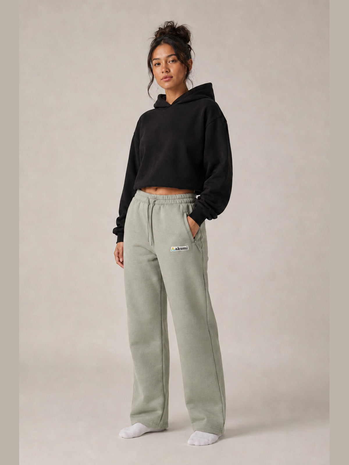 Akumi Transitline Straight-Leg Travel Sweatpant in Sage Fog, cleaned Akumi logo, female model three-quarter front view