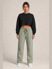 Akumi Transitline Straight-Leg Travel Sweatpant in Sage Fog, cleaned Akumi logo, female model front view