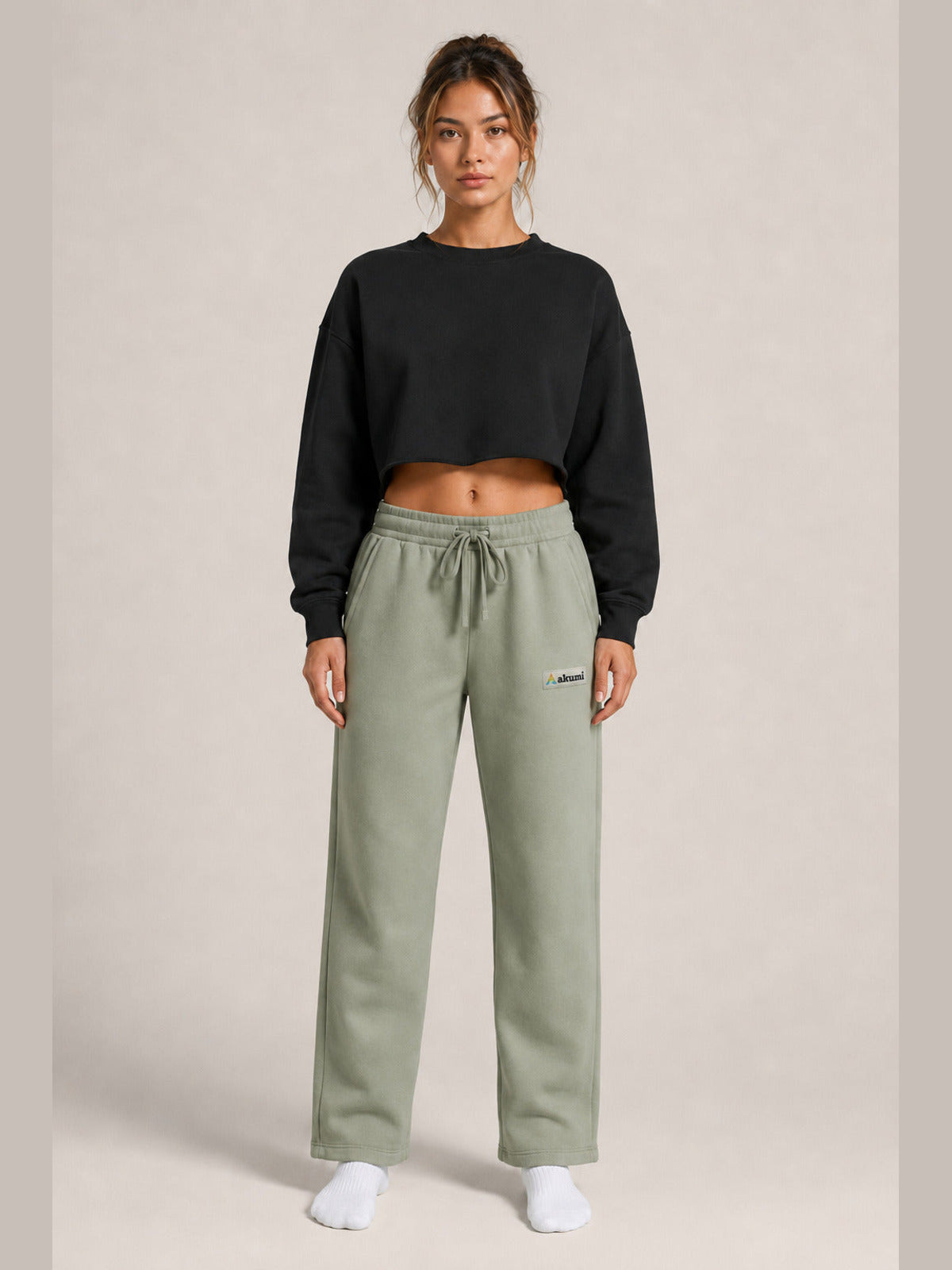 Akumi Transitline Straight-Leg Travel Sweatpant in Sage Fog, cleaned Akumi logo, female model front view