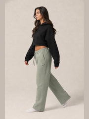 Akumi Transitline Straight-Leg Travel Sweatpant in Sage Fog, cleaned Akumi logo, side walking view with zip pocket