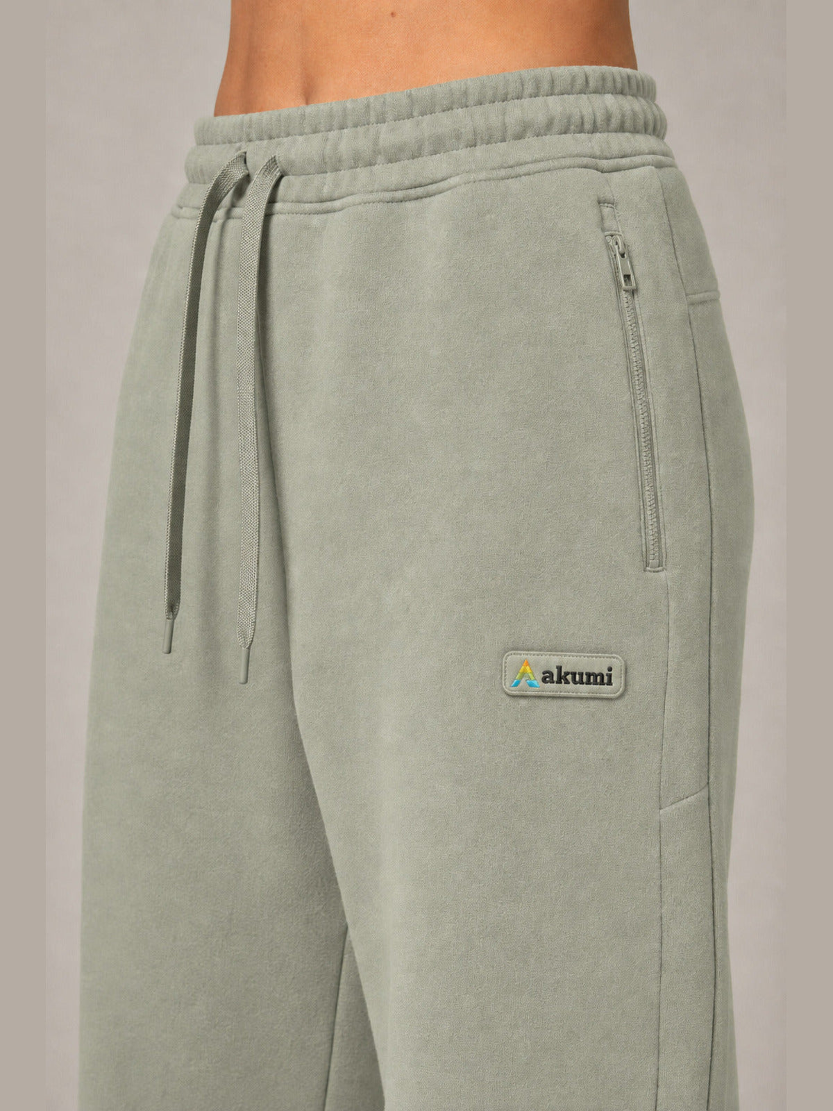 Akumi Transitline Straight-Leg Travel Sweatpant in Sage Fog, cleaned Akumi logo and zip pocket detail