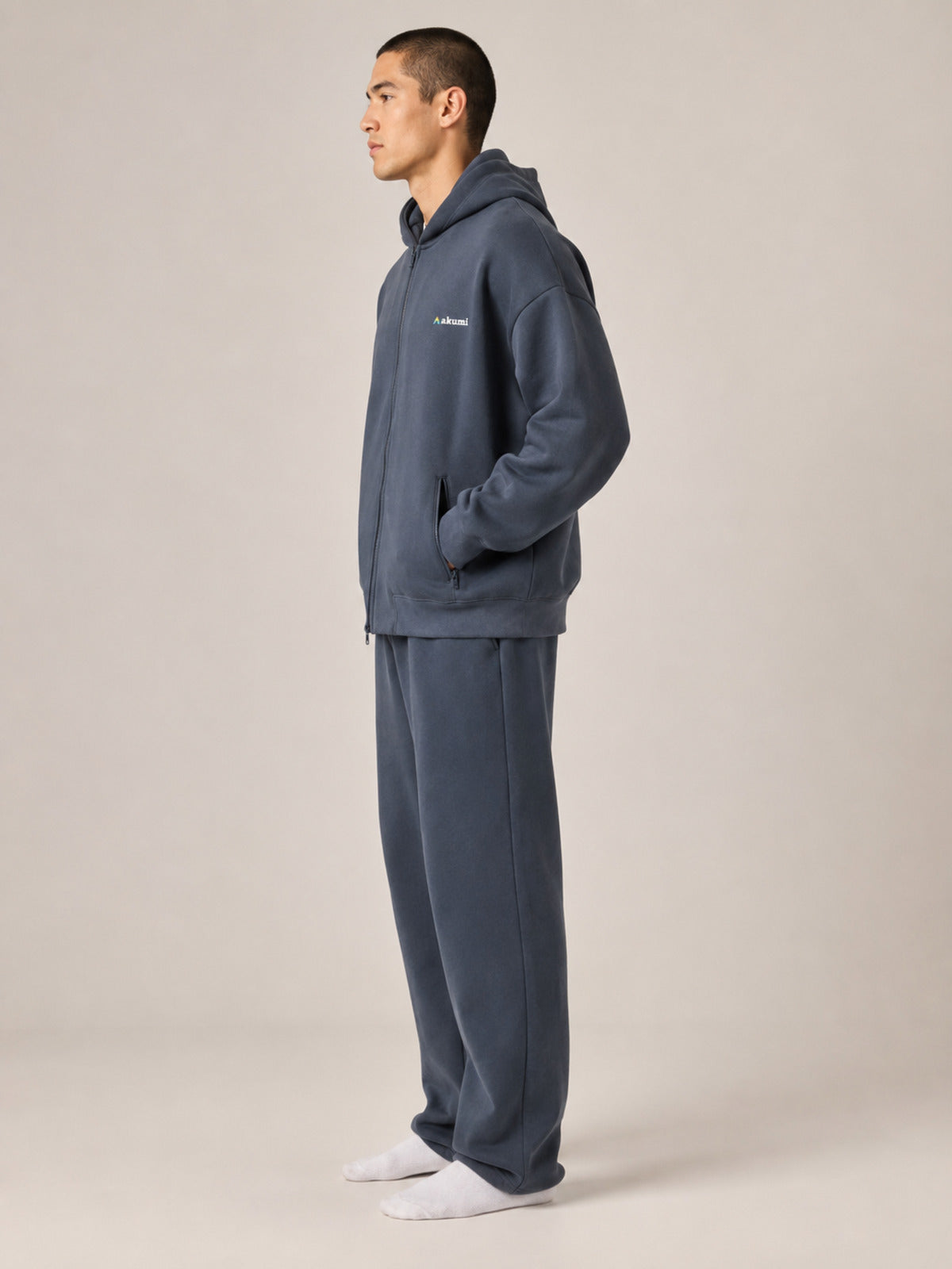 Akumi Waypoint Zip Hoodie in Graphite Sky male full-body side studio view
