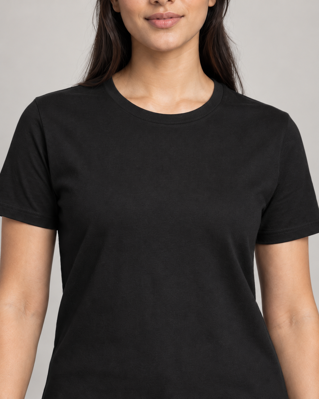 Generated concept mockup: Women's Dayform Crew Tee in Black, construction detail view highlighting crew neckline, shoulder seam, sleeve attachment and upper-chest stitching.