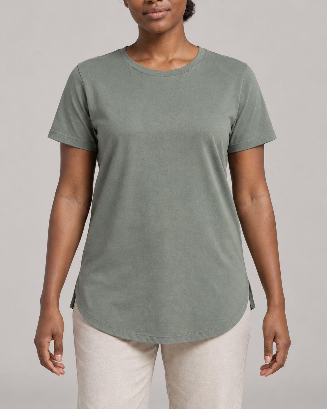 Generated concept mockup: Women's Dayform Longline Tee in Eucalyptus, construction detail view highlighting crew neckline, short-sleeve seam, curved lower hem and small side opening.