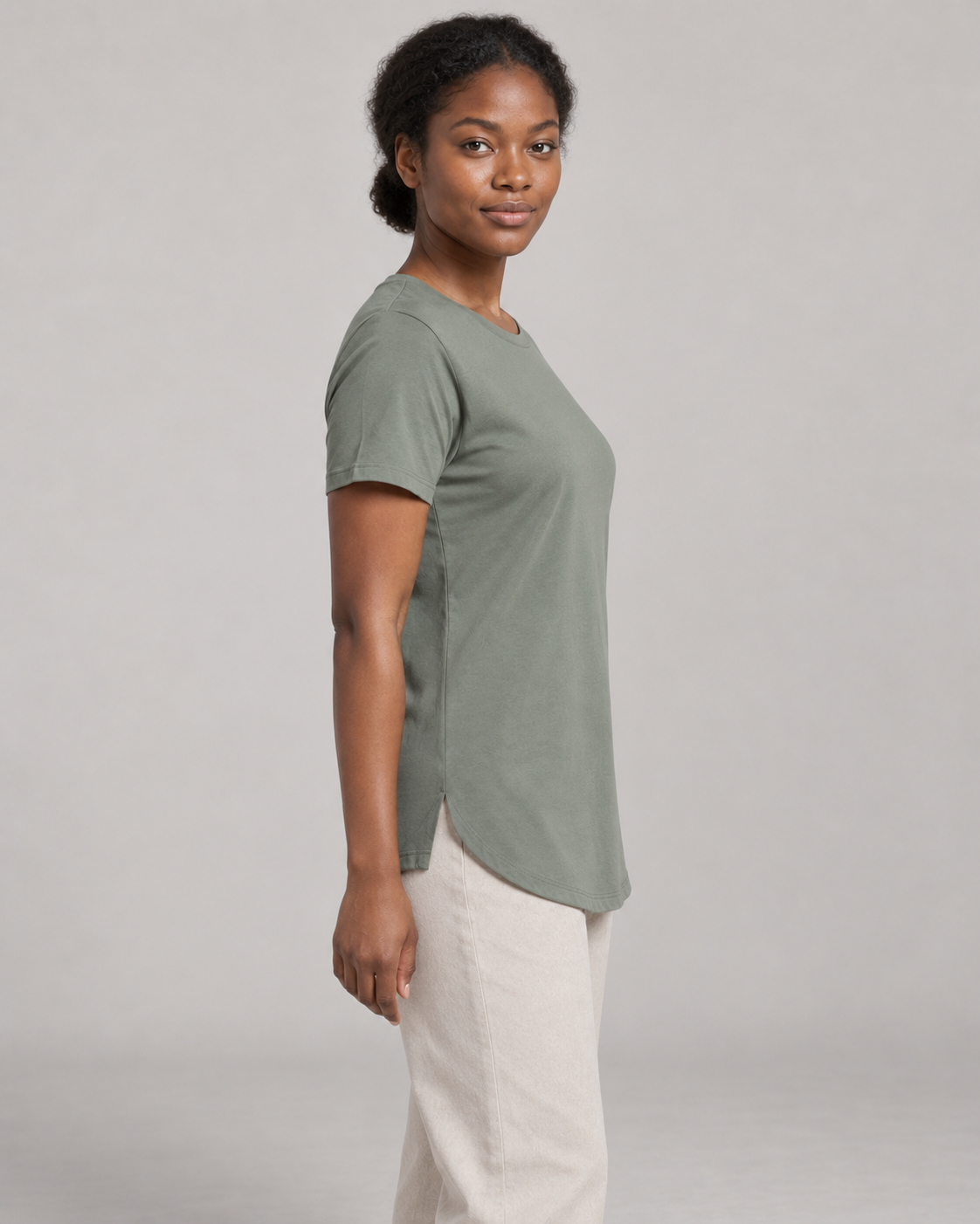Generated concept mockup: women's Dayform Longline Tee in Eucalyptus, side view on model.