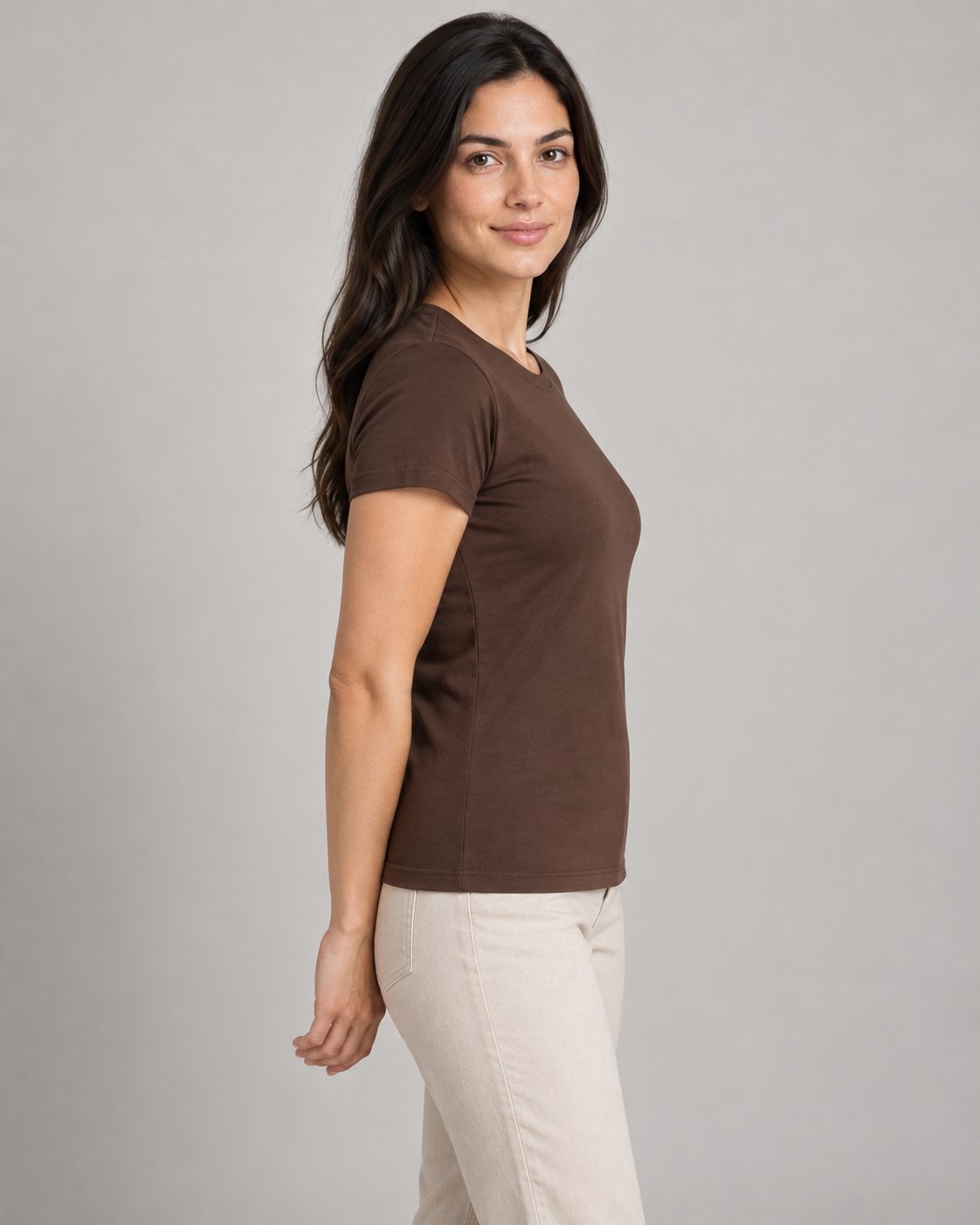 Generated concept mockup: women's Outline Fitted Tee in Cocoa, side view on model.