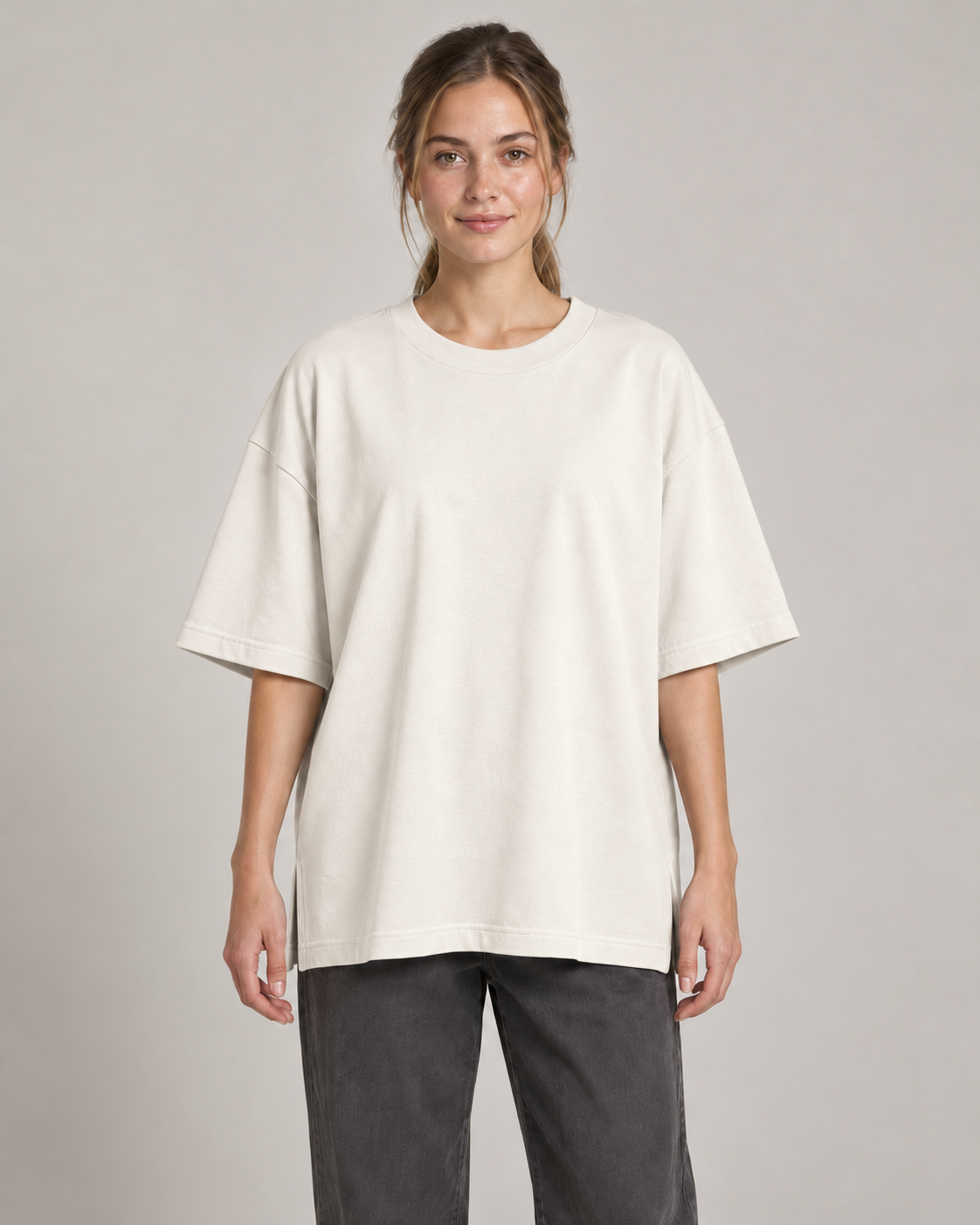 Generated concept mockup: Women's Still Oversized Tee in Chalk, front view on model.